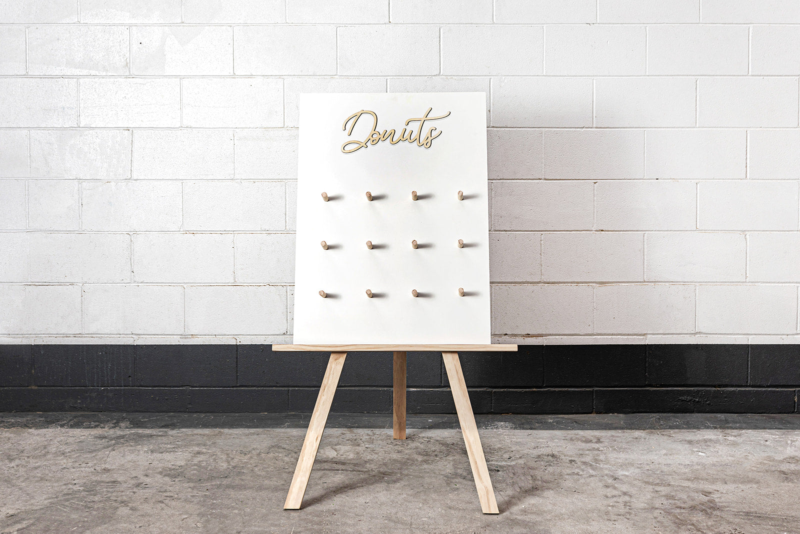 Donut wall displayed on easel stand for event dessert station in Auckland