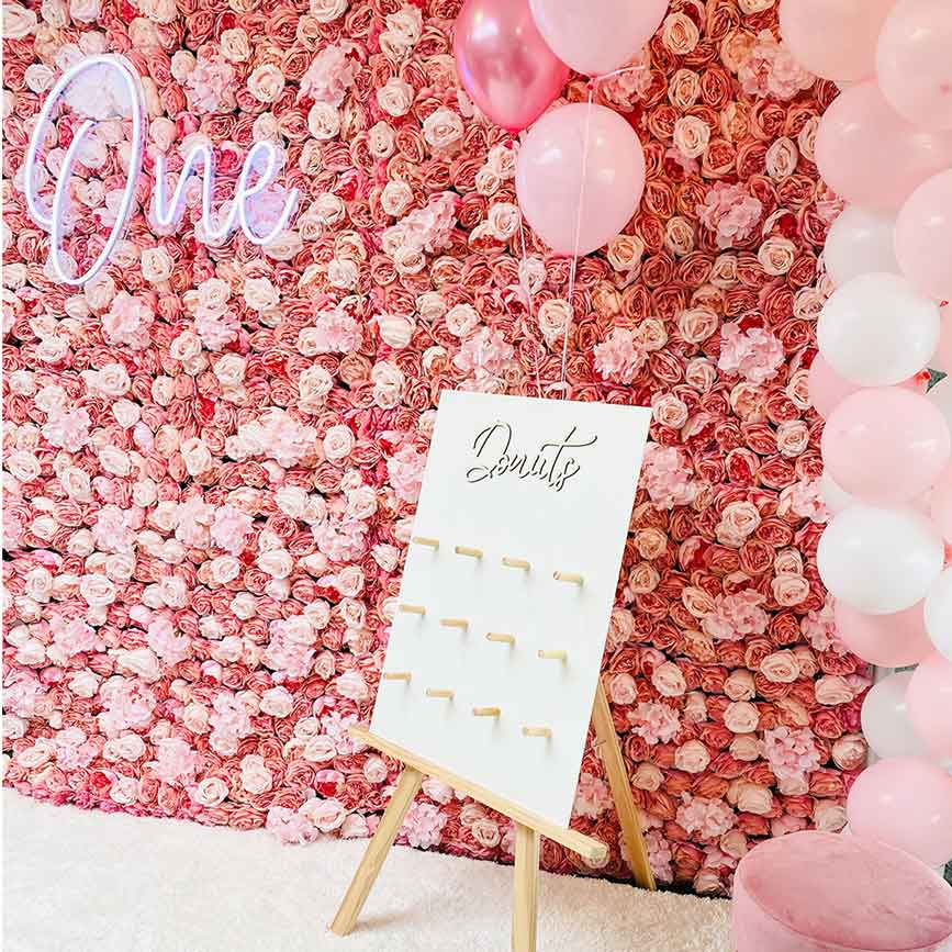 Colorful flower wall backdrop for first birthday party celebration