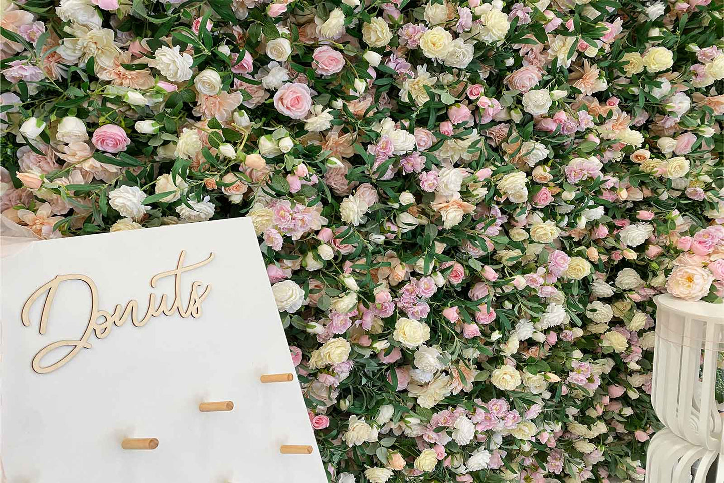 Flower wall backdrop with donut wall display for events