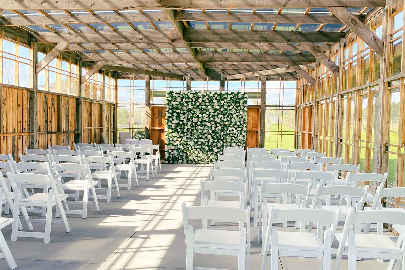Classic green and white flower wall for wedding ceremony and reception styling 