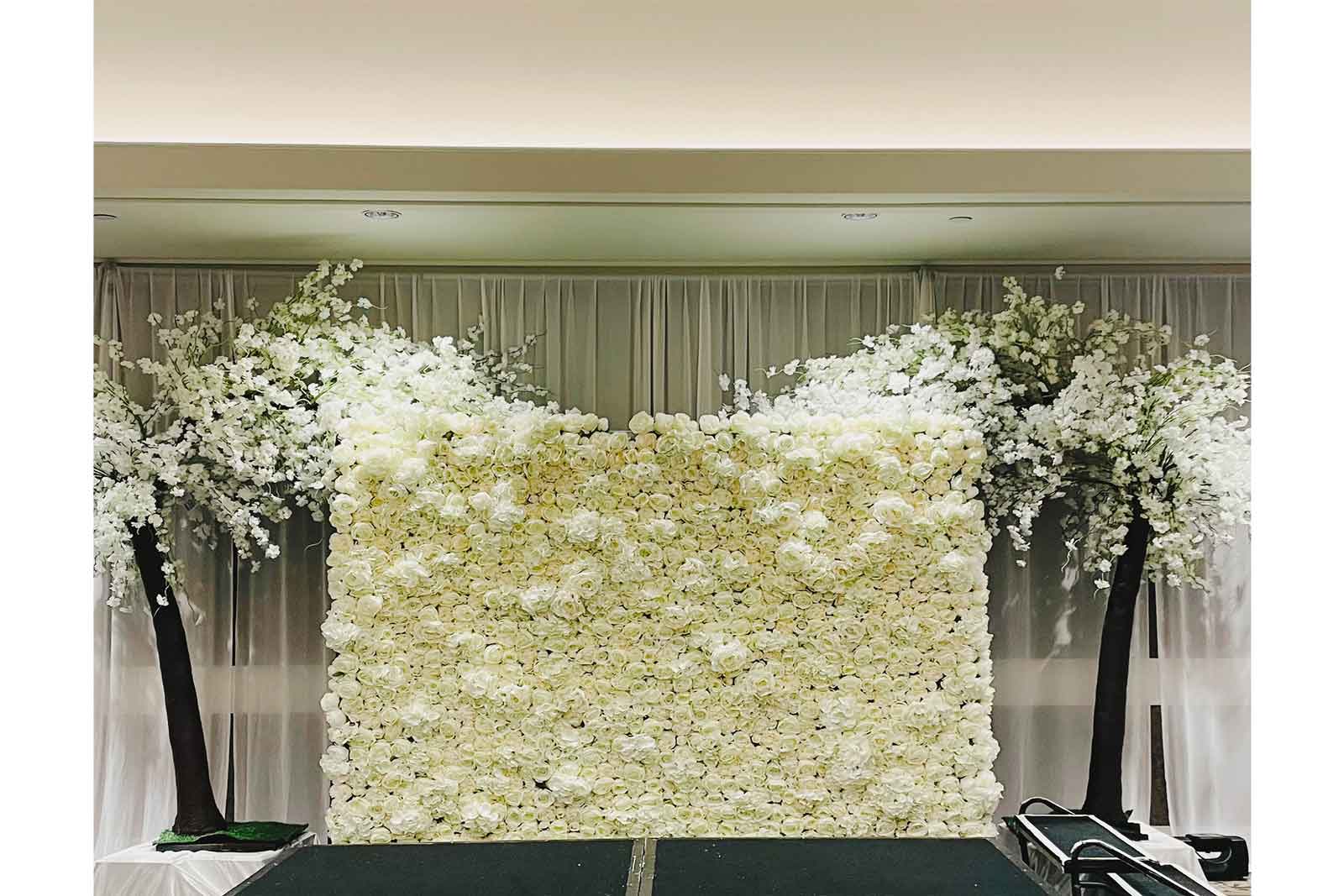 Wedding photo backdrop featuring a luxury white flower wall