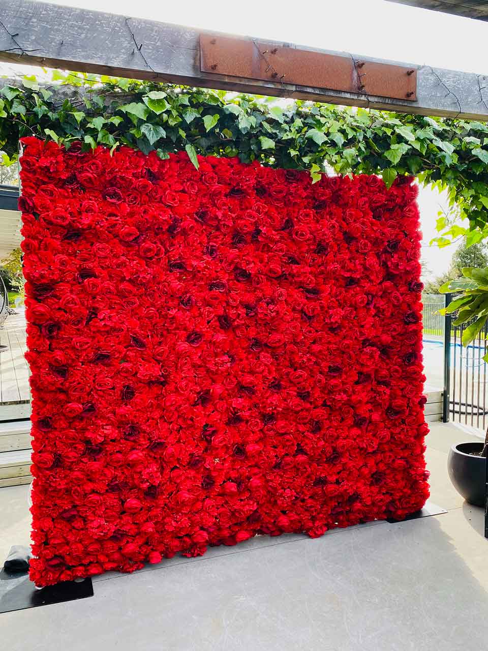 Red floral wall backdrop for events, photo booths, and celebrations across Auckland, New Zealand