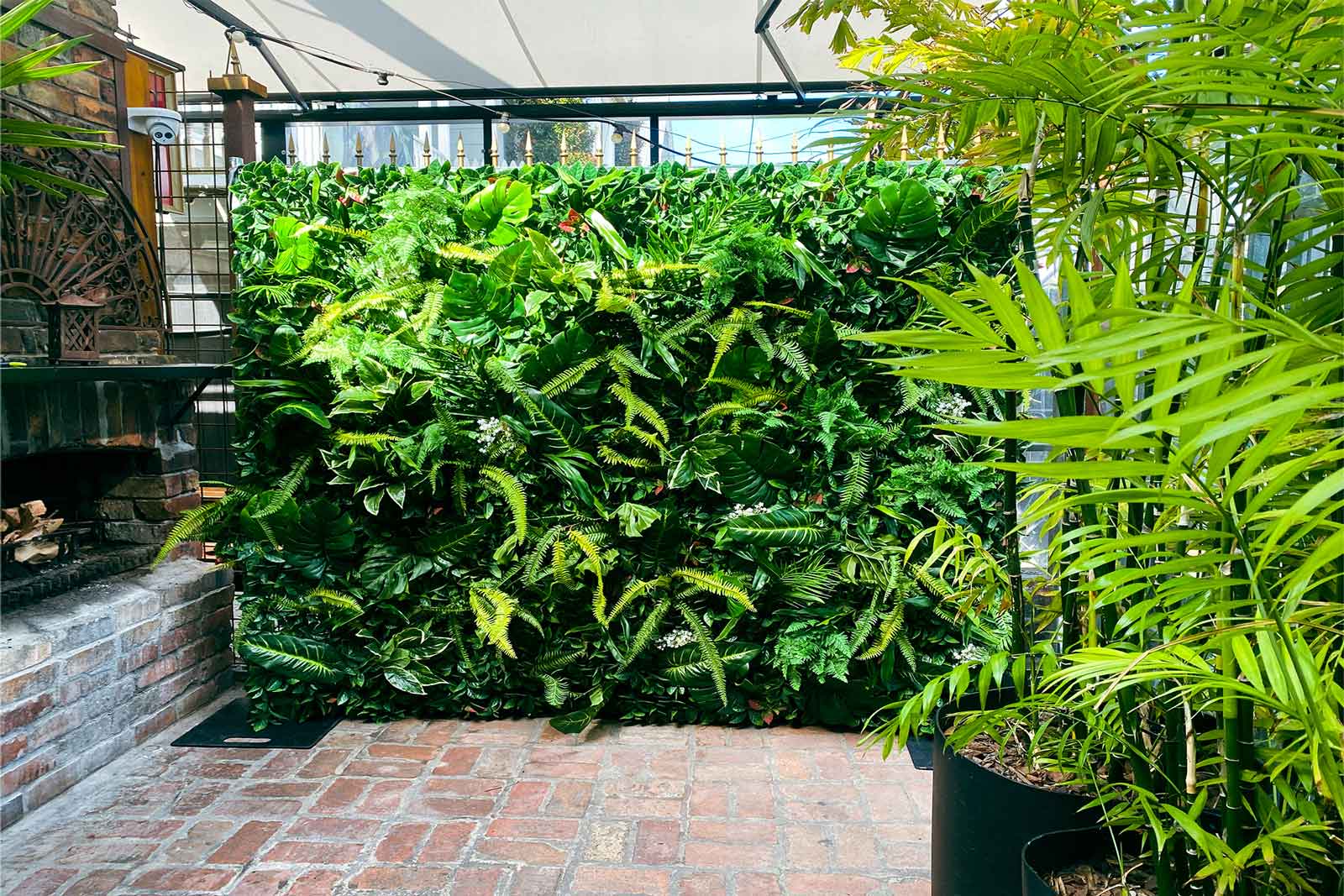 Tropical greenery wall backdrop for corporate event styling