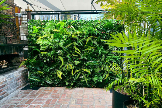 Tropical greenery wall backdrop for corporate event styling