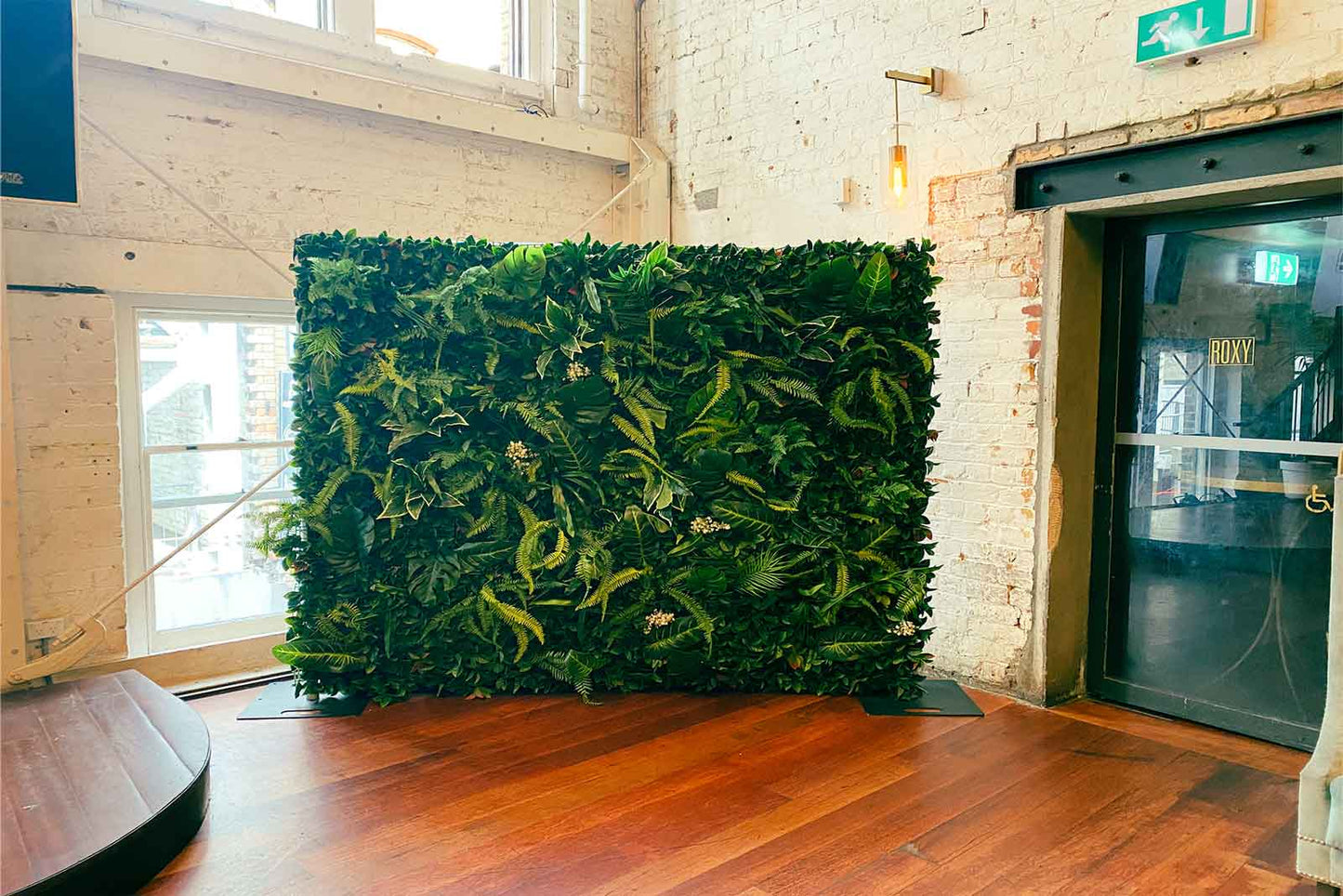 Tropical greenery wall backdrop featuring lush leaves and foliage for weddings, birthdays and corporate events in Auckland