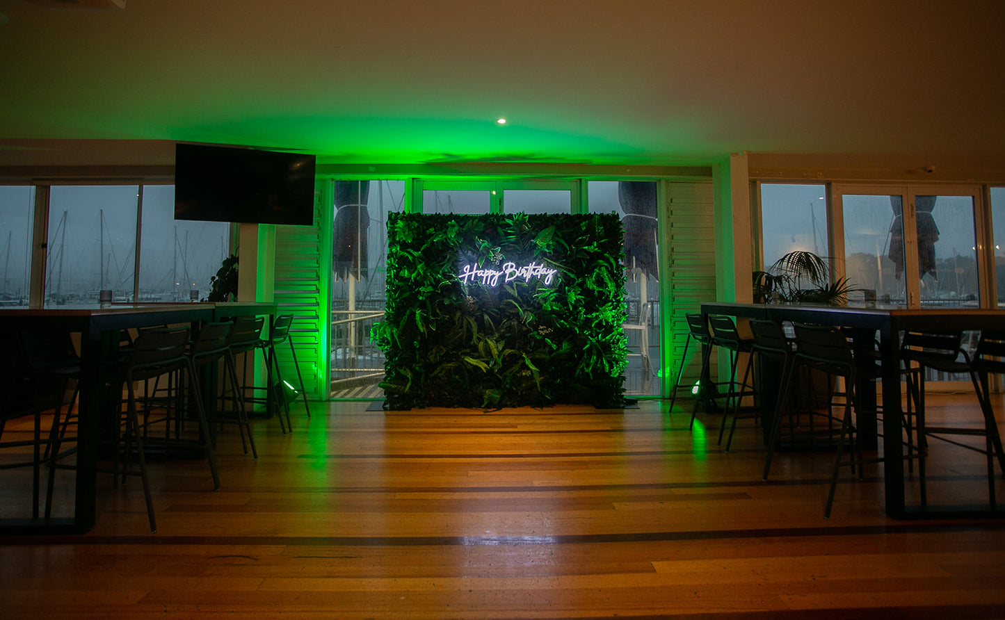 Luxury tropical leaf wall for event hire, creating a vibrant jungle-inspired backdrop for photos and celebrations