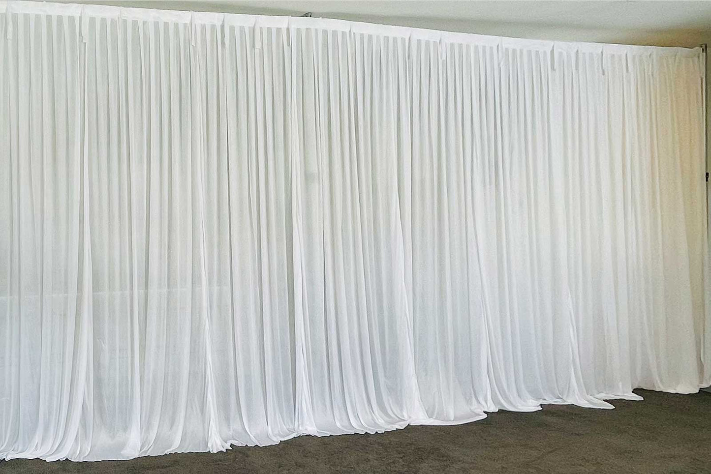 White curtain hire for weddings, parties, and elegant event backdrops