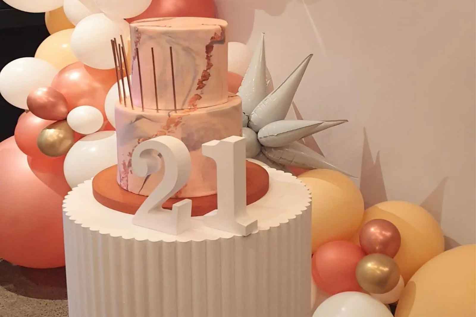 White ribbed plinth hire NZ styled with balloons and flowers